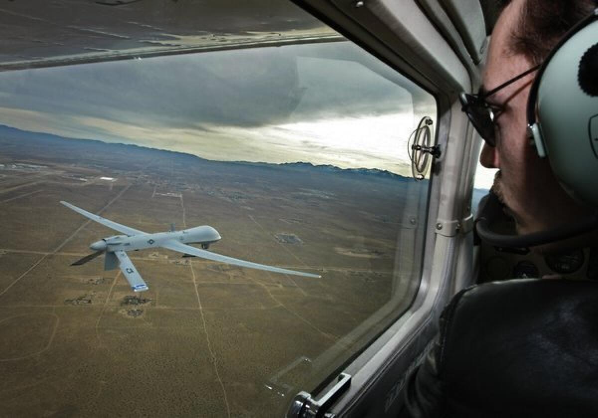 Pilot Mark Bernhardt keeps an eye on a Predator unmanned drone from his chase plane as they fly over Victorville.