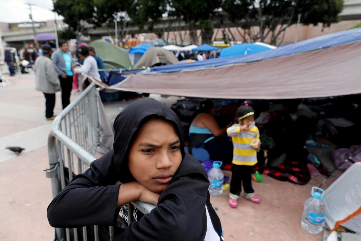 Brian Casares, 12, of Honduras, along with other Central Americans, waits for an appointment to apply for asylum at an encampment near the Chaparral port of entry in Tijuana on May 1, 2018.