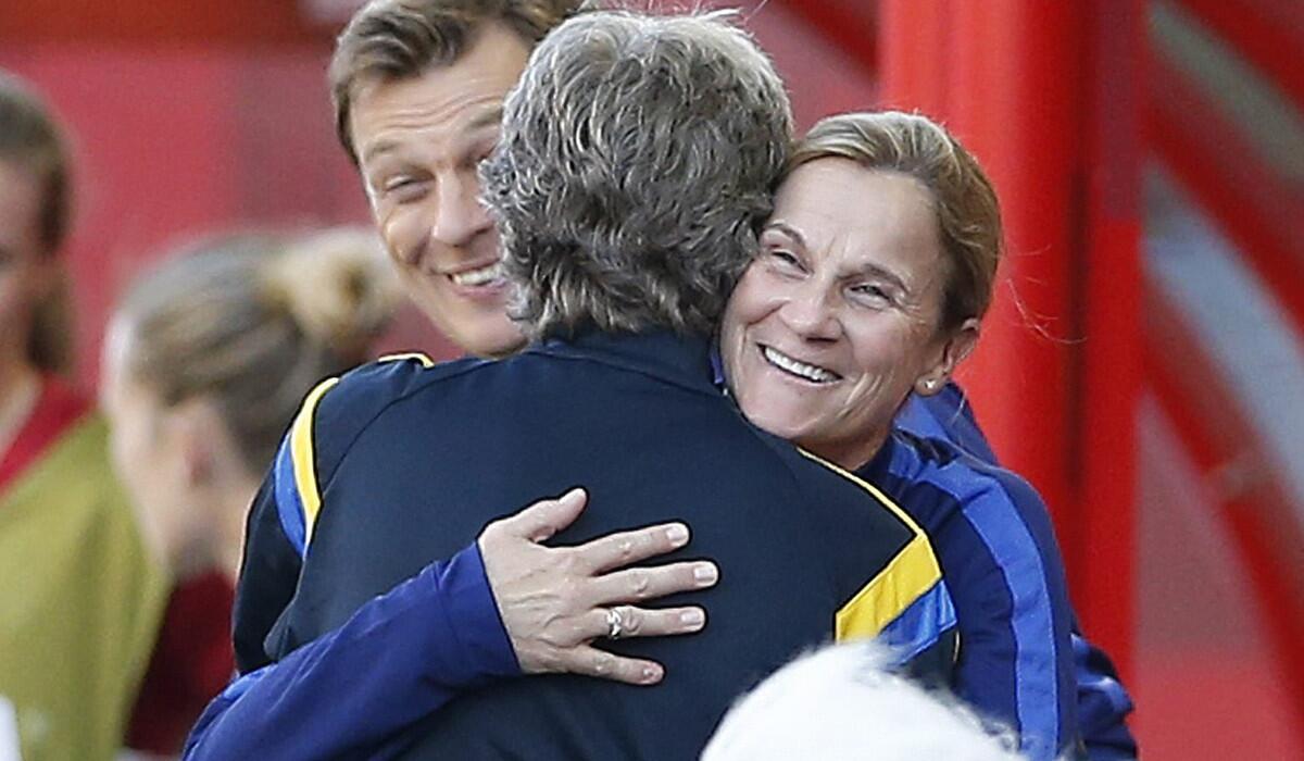 U.S. Coach Jill Ellis, right, and Sweden Coach Pia Sundhage embrace prior to their teams' World Cup match Friday in Winnipeg.