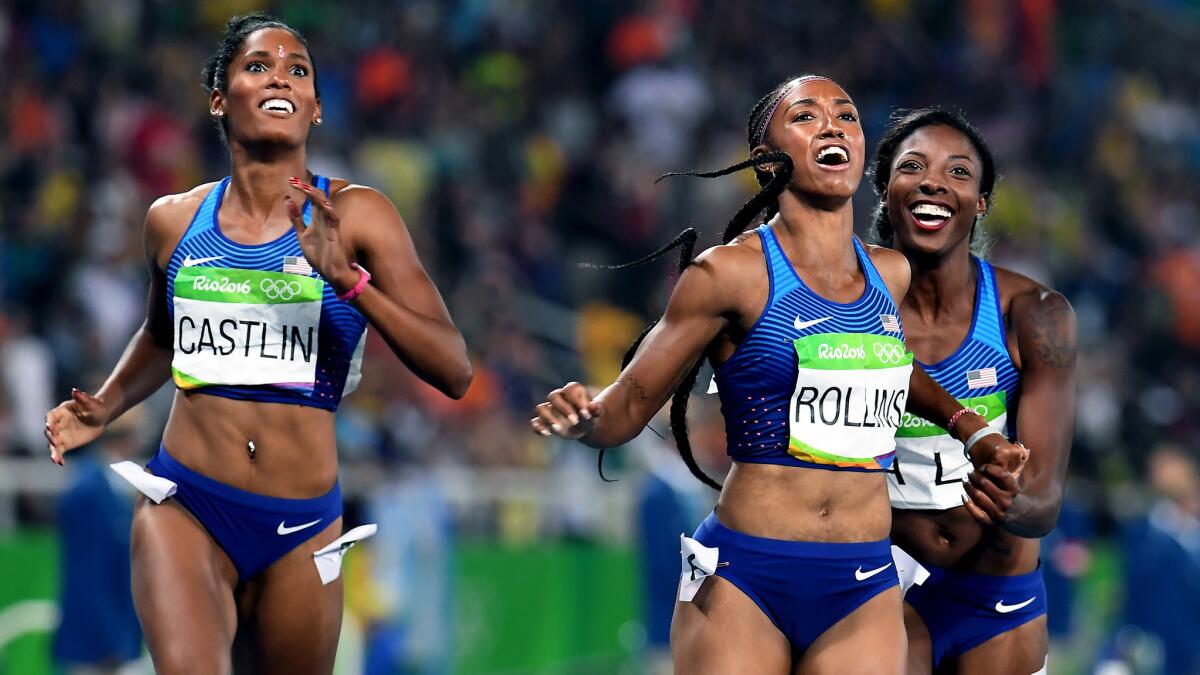 American hurdlers (from left) Kristi Castlin, Brianna Rollis and Nia Ali check the scoreboard to see that they swept the women's 100-meter hurdles.