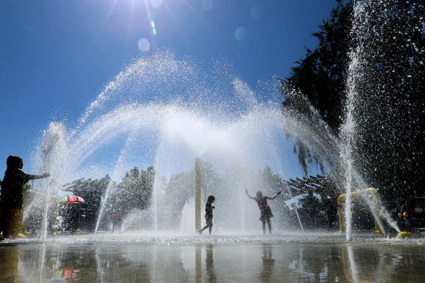 Fullerton, CA - August 04: Kids cool off amid the heat on a summer day at the Lemon Park Spray Pool in Fullerton Friday, Aug. 4, 2023. (Allen J. Schaben / Los Angeles Times)