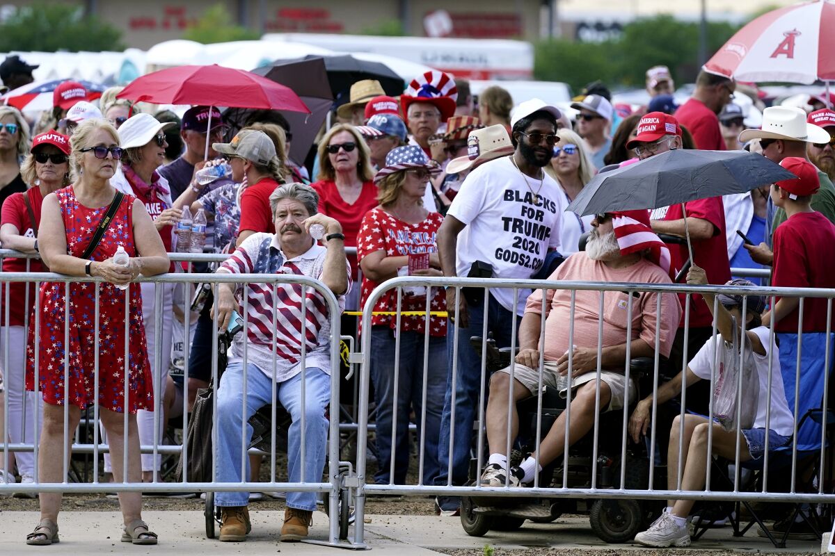 Supporters of former President Donald Trump wait in line hours before the former president is set to speak at a ally Friday, July 22, 2022, in Prescott, Ariz. (AP Photo/Ross D. Franklin)