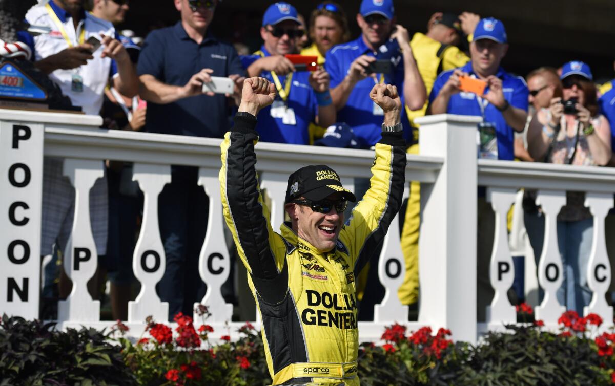 Matt Kenseth celebrates in Victory Lane after winning the NASCAR Pocono 400 auto race Sunday in Long Pond, Pa.