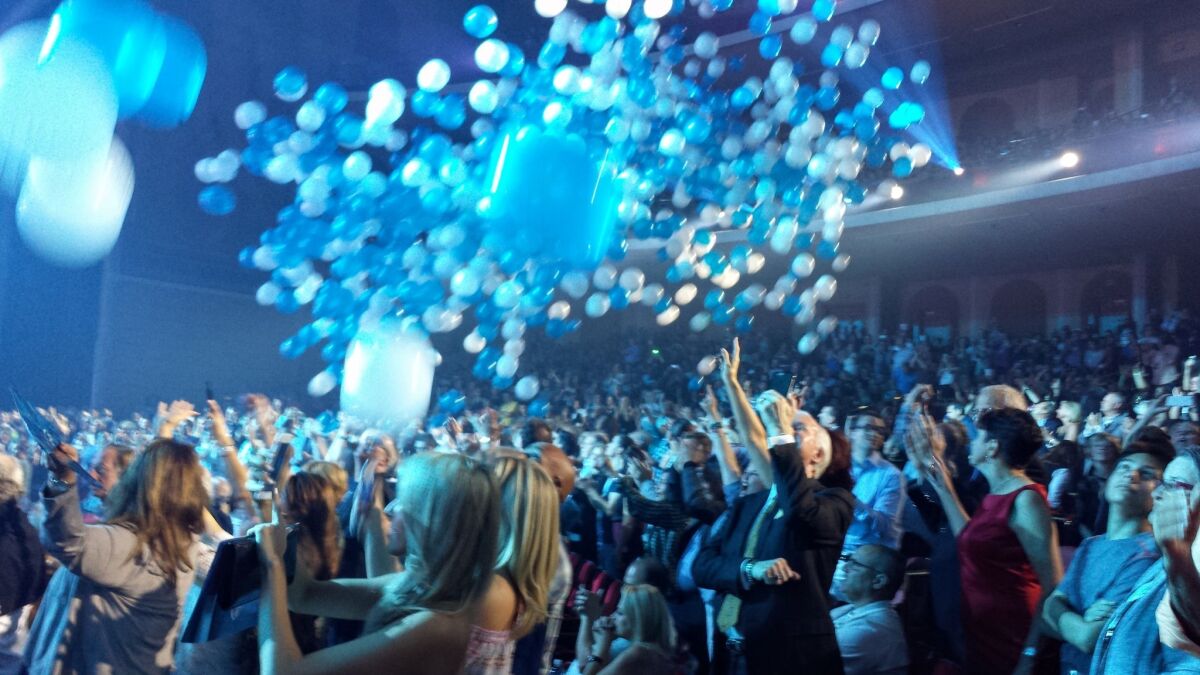 Balloons and confetti fall from rafters at the end of Celine Dion's Saturday show.