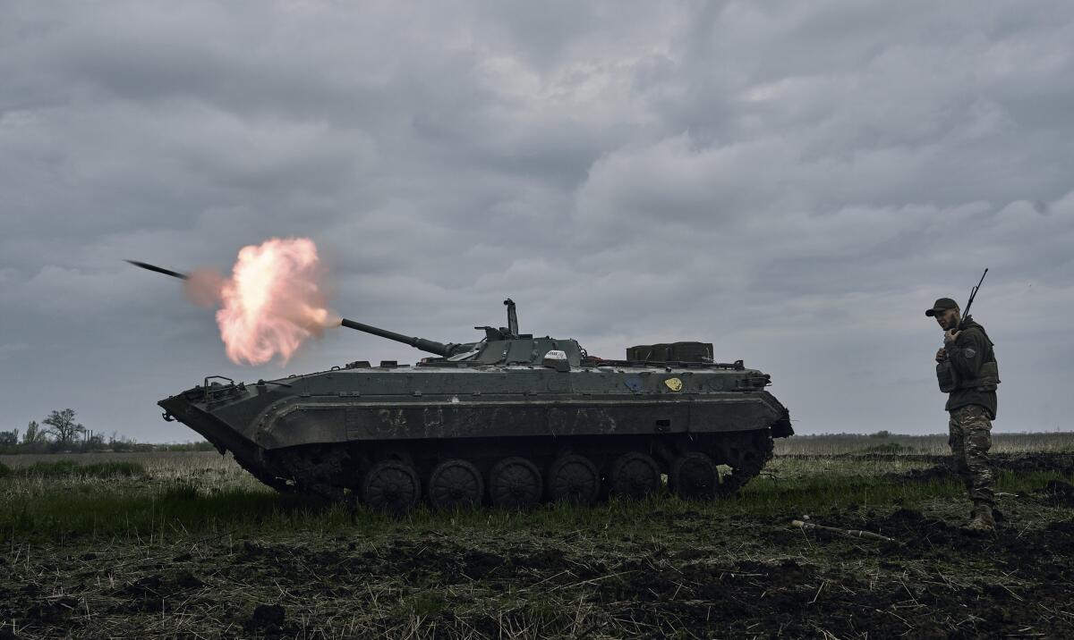 Ukrainian armored vehicle firing toward Russian positions near Avdiivka in eastern Ukraine