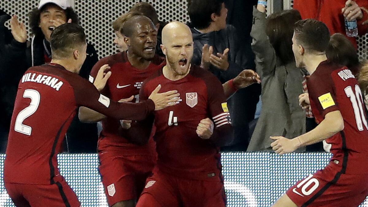 U.S. midfielder Michael Bradley (4) celebrates his goal with teammates during the first half against Honduras on Friday night. (Marcio Jose Sanchez / Associated Press)