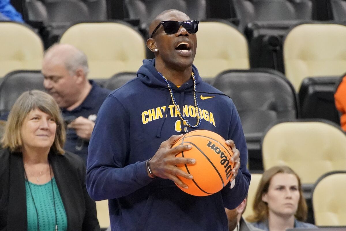 Pro Football Hall of Fame wide receiver Terrell Owens watches as Chattanooga warms up before a college basketball game against Illinois in the first round of the NCAA tournament in Pittsburgh, Friday, March 18, 2022. (AP Photo/Gene J. Puskar)