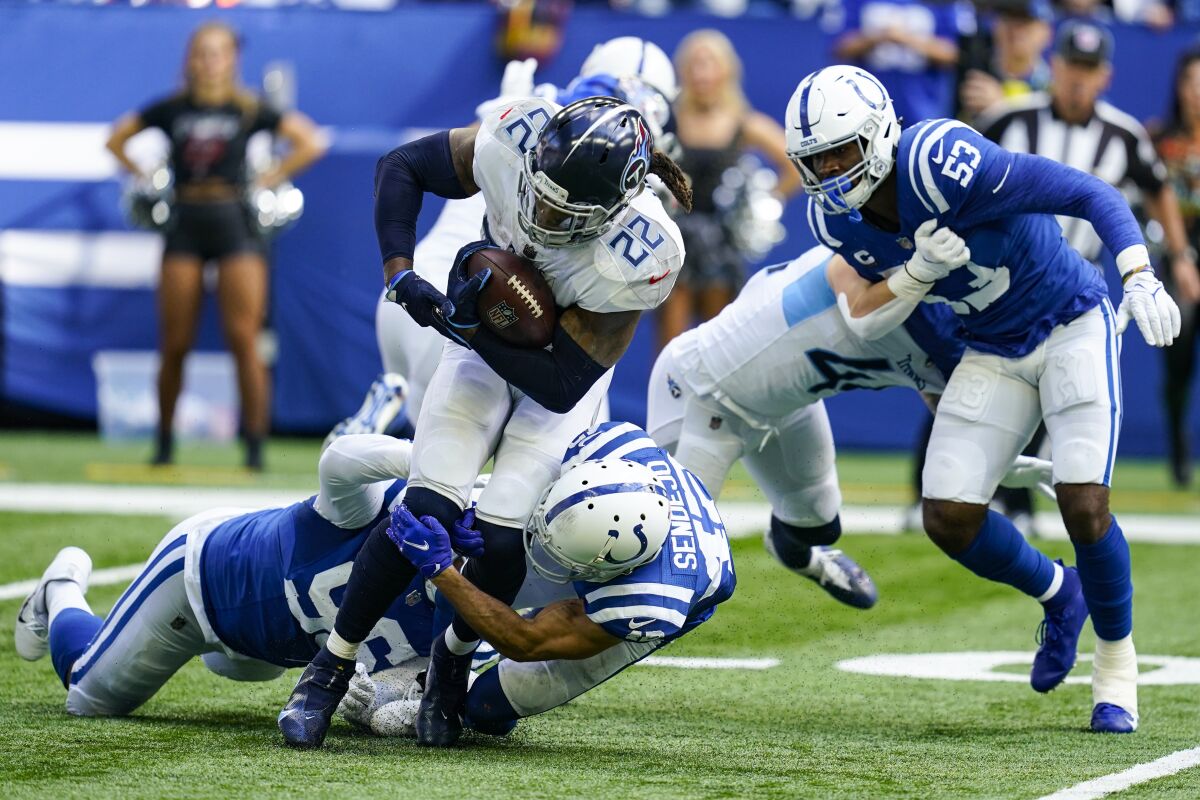 Tennessee Titans running back Derrick Henry (22) is tackled by Indianapolis Colts safety Andrew Sendejo (42) in the second half of an NFL football game in Indianapolis, Sunday, Oct. 31, 2021. (AP Photo/Darron Cummings)