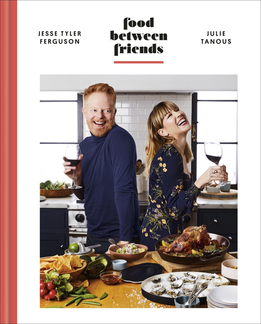 This cover image shows "Food Between Friends" by Jesse Tyler Ferguson and Julie Tanous. (Clarkson Potter via AP)