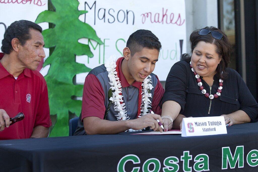 Costa Mesa High senior volleyball standout Mason Tufuga, center, accompanied by his mother Yvette and father Mai as he signs his intent to play for Stanford University.