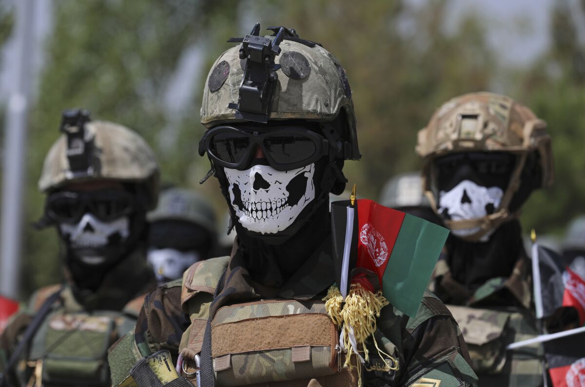 Masked Afghan army special forces attend their graduation ceremony