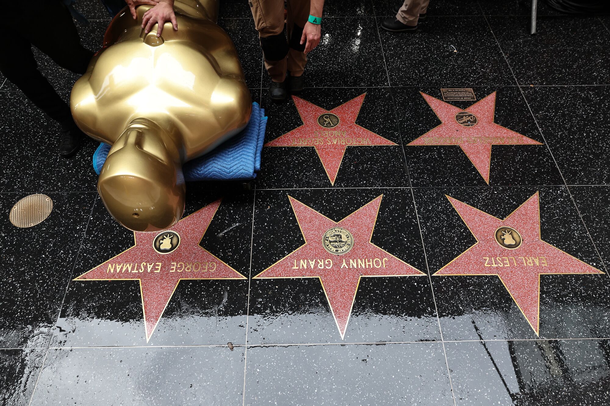 Crews deliver an outsized Oscar statue as preparations for the 95th Academy Awards on Hollywood