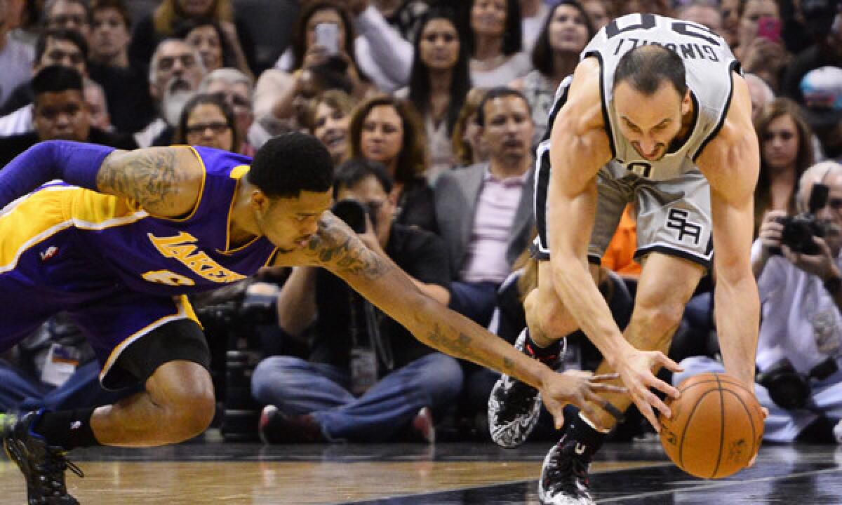 Lakers guard Kent Bazemore, left, loses the ball to San Antonio Spurs guard Manu Ginobili during the Lakers' loss Friday.