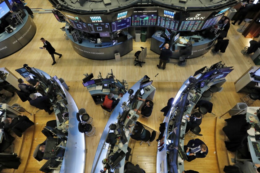 Traders work on the floor of the New York Stock Exchange, which rallied Monday after last week's steep declines.