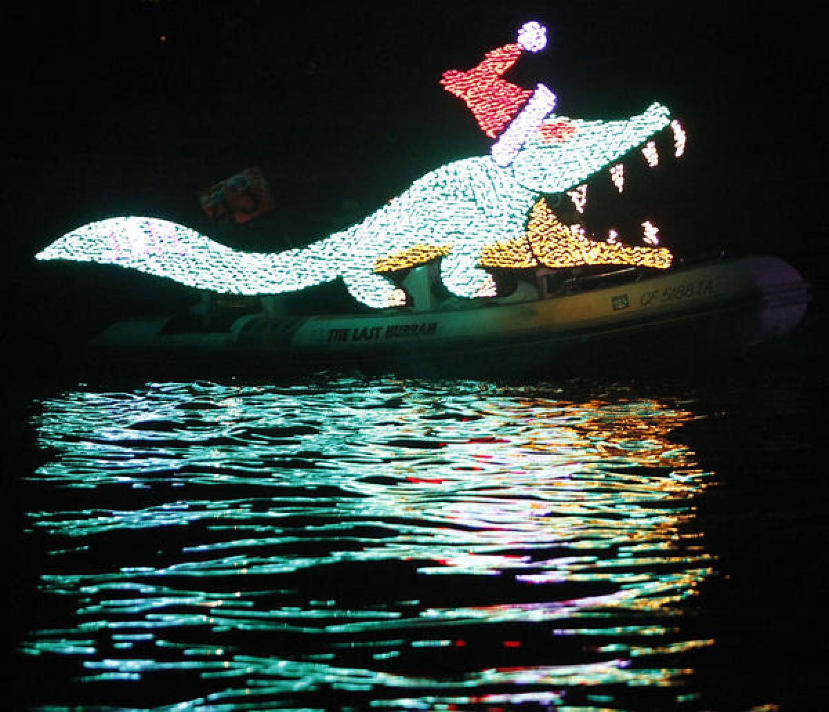 A crocodile flows behind The Last Hurrah, by J. Roberts and Elizabeth Meadows, during the 103rd annual Newport Beach Christmas Boat Parade in 2011.