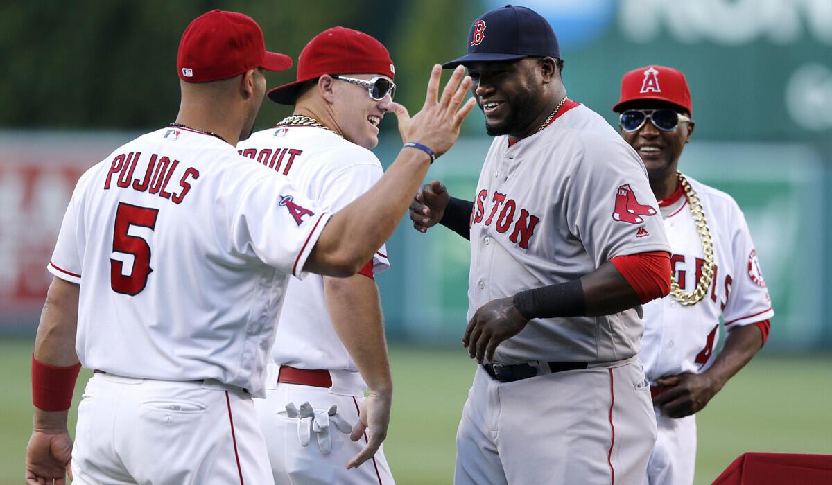 Boston Red Sox's David Ortiz, second from right, is greeted on the mound by Angels' Albert Pujols, left, and Mike Trout, second left, and infield coach Alfredo Griffin before Thursday's game at Angel Stadium.