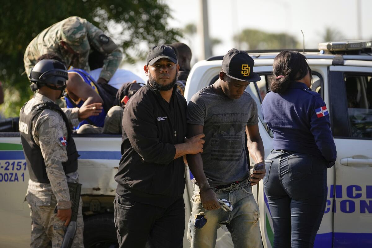 Migration officials detain undocumented Haitians in Santo Domingo, Dominican Republic.