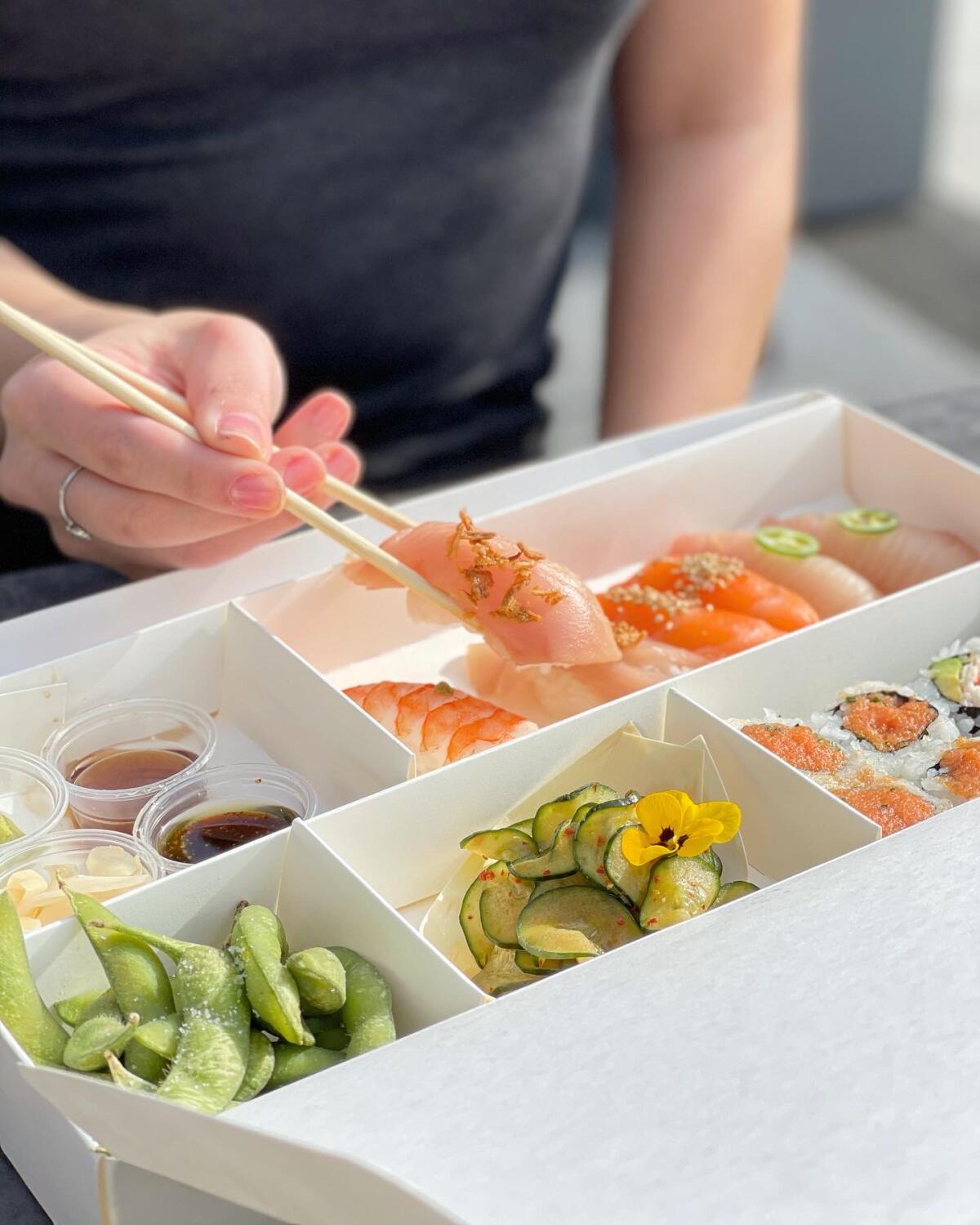 A Yakumi customized bento box of nigiri and sushi rolls.