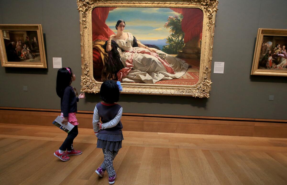 Sisters Cynthia Ying, 5, and Diana Ying, 7, look at classical European paintings during a visit to the Getty Center in Brentwood on Feb. 17, 2015.