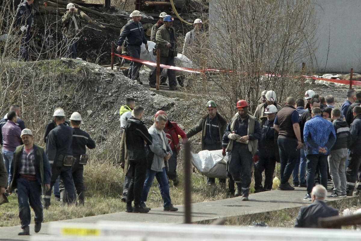 Rescue workers carry a body after a shaft collapsed in Soko coal mine, in central Serbia, Friday, April 1, 2022. Serbian authorities say that an accident in a mine in central Serbia has killed 8 people and wounded 18. The Soko mine, about 200 kilometers (125 miles) southeast of Belgrade, has had several serious accidents since it started operating in the early 1900s. An accident in the mine in 1998 killed 29 miners. (AP Photo)