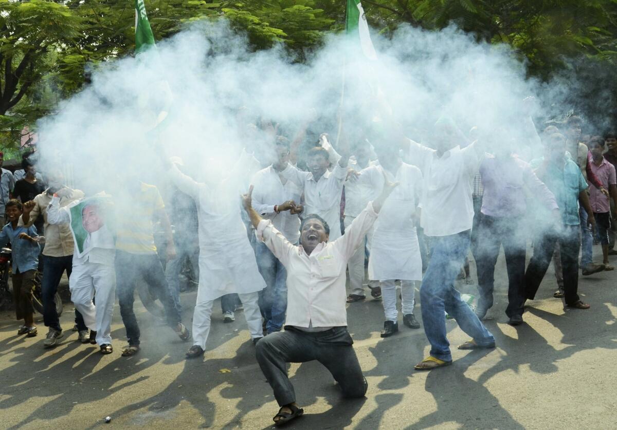 Supporters of an alliance of parties opposed to India’s ruling Bharatiya Janata Party light firecrackers to celebrate as early results of Bihar state elections indicate victory for them in Patna, India, on Sunday.