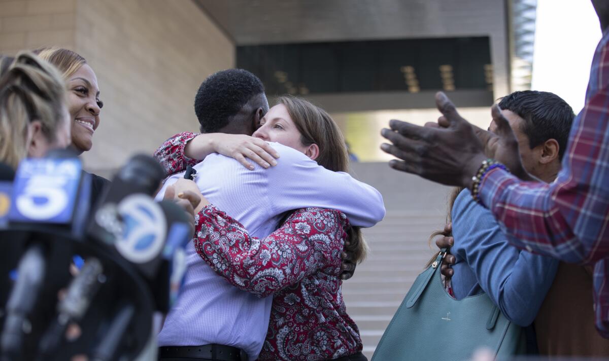 Dane Brown hugs Assistant U.S. Atty. Lindsay Bailey outside a Los Angeles federal courthouse.