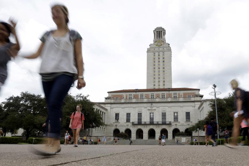 FILE - In this Sept. 27, 2012, file photo, students walk through the University of Texas at Austin campus near the school's iconic tower in Austin, Texas. A ban on diversity, equity and inclusion initiatives in higher education has led to more than 100 job cuts across university campuses in Texas, a hit echoed or anticipated in numerous other states where lawmakers are rolling out similar policies during an important election year. (AP Photo/Eric Gay, File)