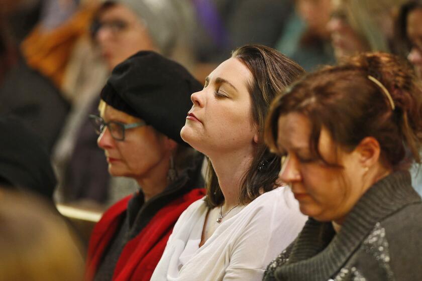 Mourners attend a vigil at All Souls Unitarian Universalist Church on Nov. 28, 2015, for the victims of the shooting the day before at a nearby Planned Parenthood clinic in Colorado Springs, Colo.