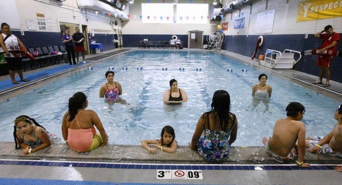 Left to right in the water, Swim instructors Violeta Oganesyan, Kyara R. and Tara Crawford and their students wait for class to begin during the World's Largest Swim Lesson at the Burbank Community YMCA on Tuesday, June 18, 2013. Locations throughout the world participated to break the Guinness World Record and spread the word that swimming lessons save lives.