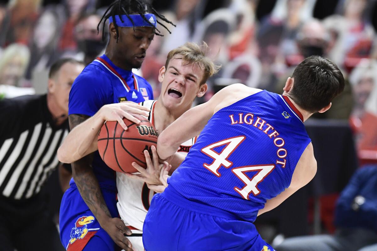 Kansas forward Mitch Lightfoot strips the ball from Texas Tech's Mac McClung.