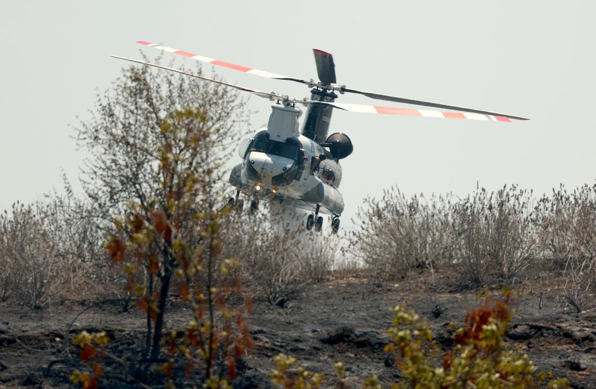 A Chinook helicopter makes a water drop