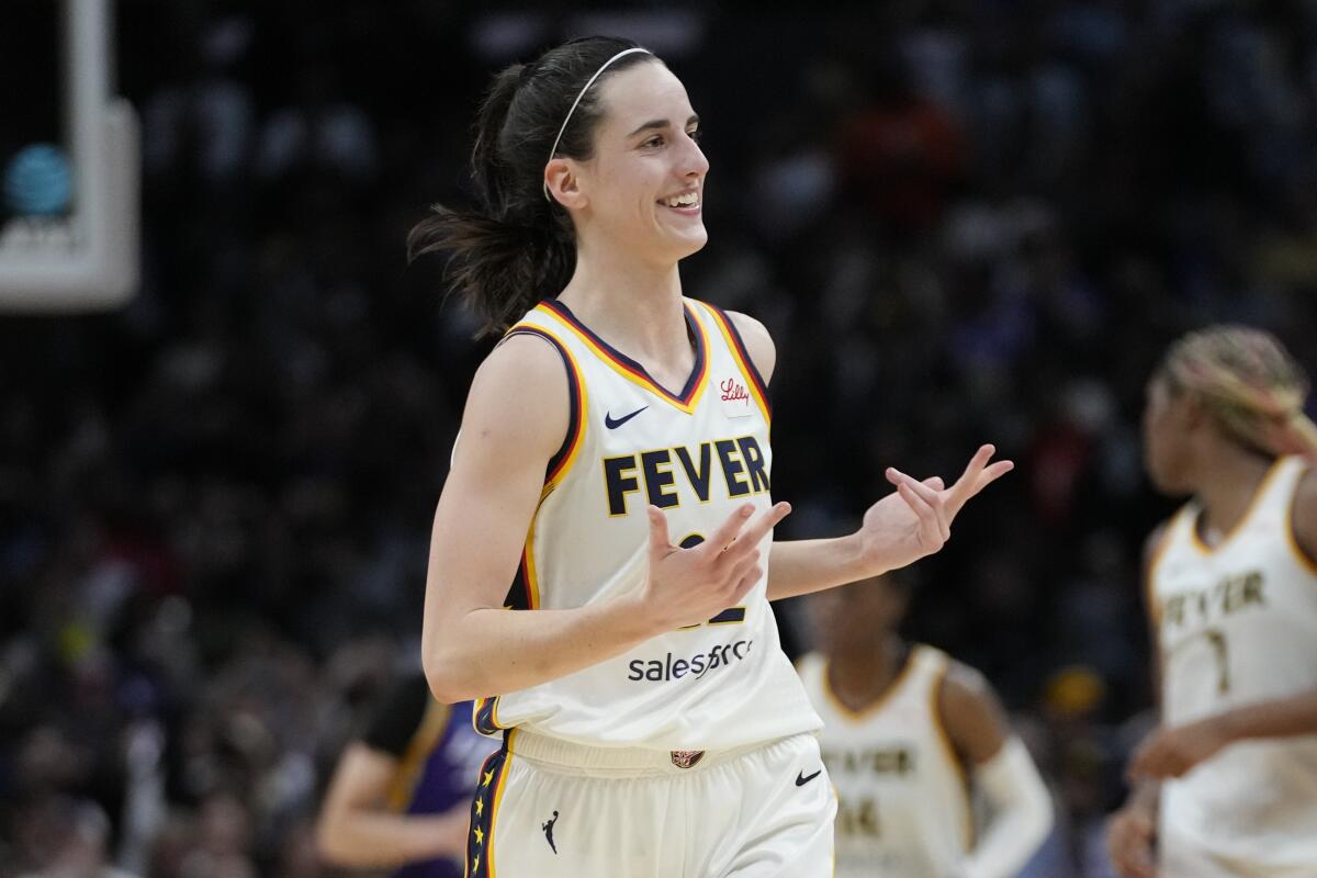 Caitlin Clark celebrates after making a three-pointer against the Sparks in May.