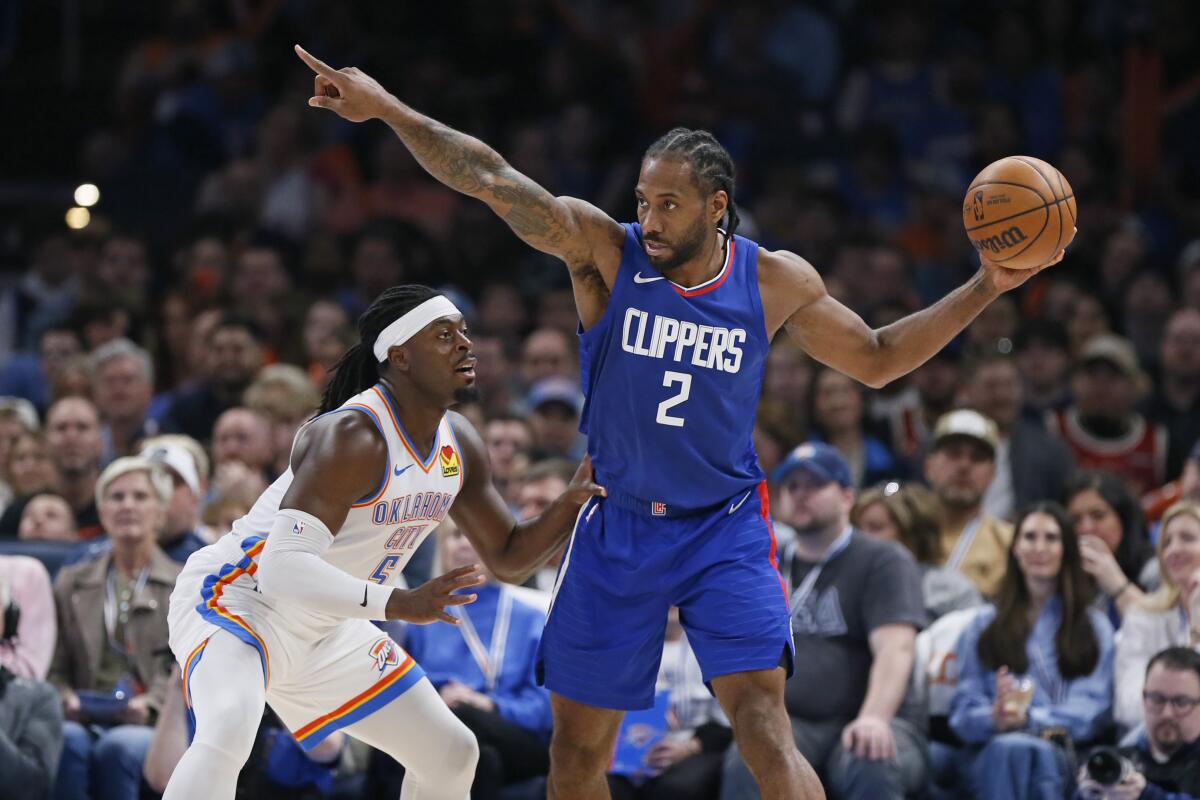 Clippers star Kawhi Leonard directs his teammates while being guarded by Oklahoma City's Luguentz Dort.