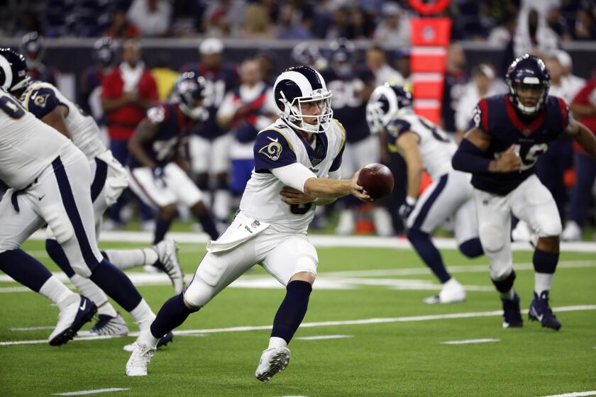 Rams quarterback John Wolford hands off the ball during the second half of a preseason victory over the Houston Texans on August 29, 2019.