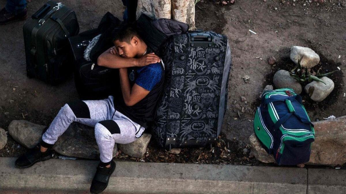An asylum seeker waits at El Chaparral port of entry in Tijuana to request asylum at the U.S. border on April 9, 2019.