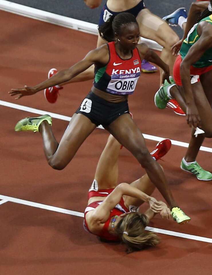 Kenya's Hellen Onsando Obiri leaps to avoid Morgan Uceny of the United States during the women's 1,500-meter final.