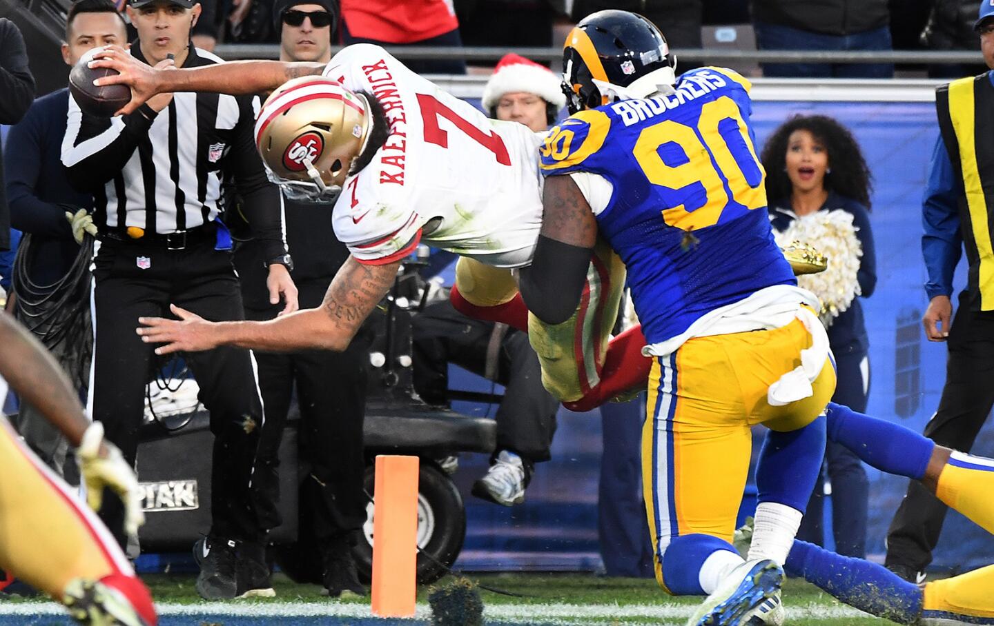 49ers quarterback Colin Kaepernick scores on a two-point conversion against Rams defensive lineman Michael Brockers late in the fourth quarter.