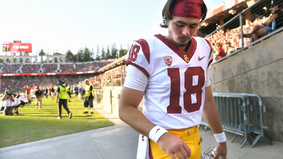 USC quarterback JT Daniels looks at his throwing hand as he heads to the locker room on Sept. 8.
