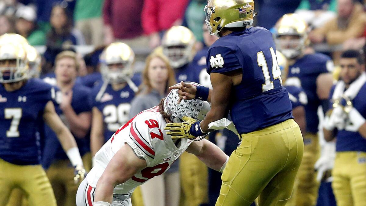 Ohio State defensive lineman Joey Bosa (97) was ejected from the Fiesta Bowl under targeting rules for this hit on Notre Dame quarterback DeShone Kizer (14).