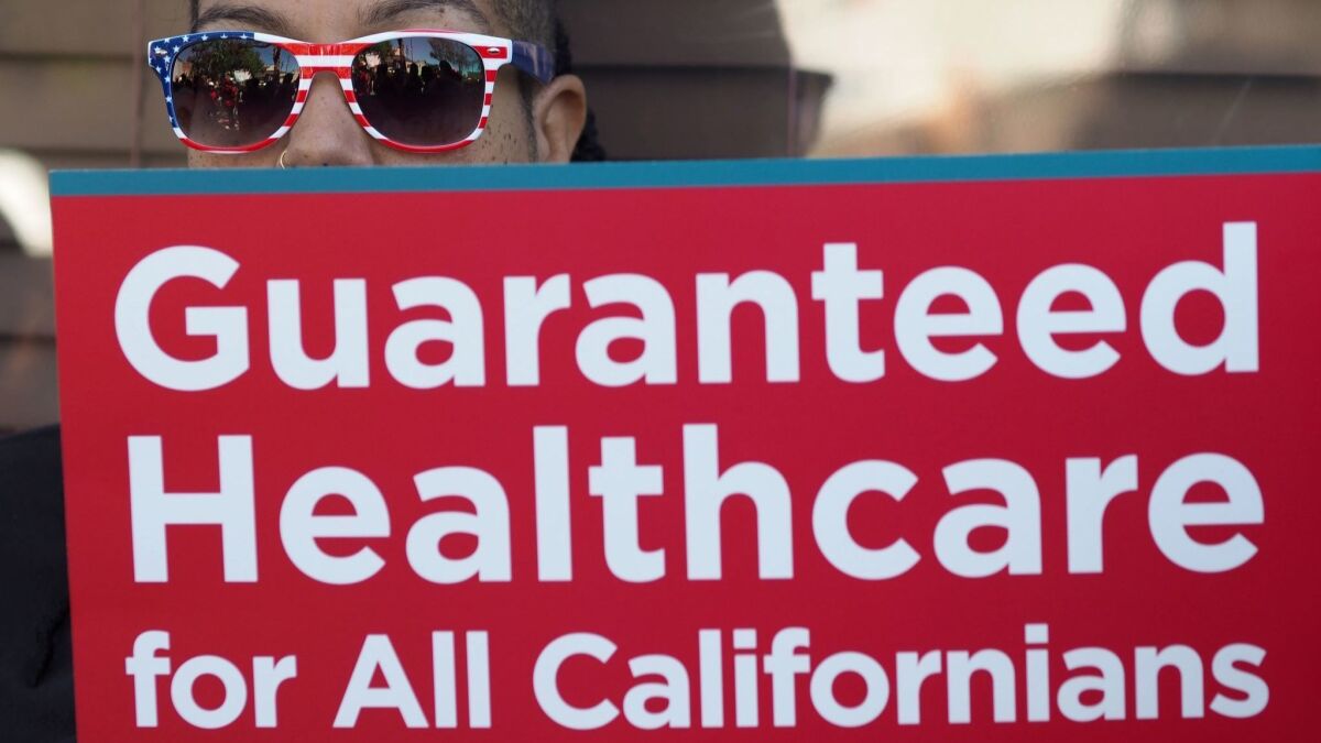 A supporter of single-payer healthcare for all Californians rallies outside the office of California Assembly Speaker Anthony Rendon in South Gate last year. A state bill was pulled from consideration, but advocates for universal healthcare aren’t giving up.