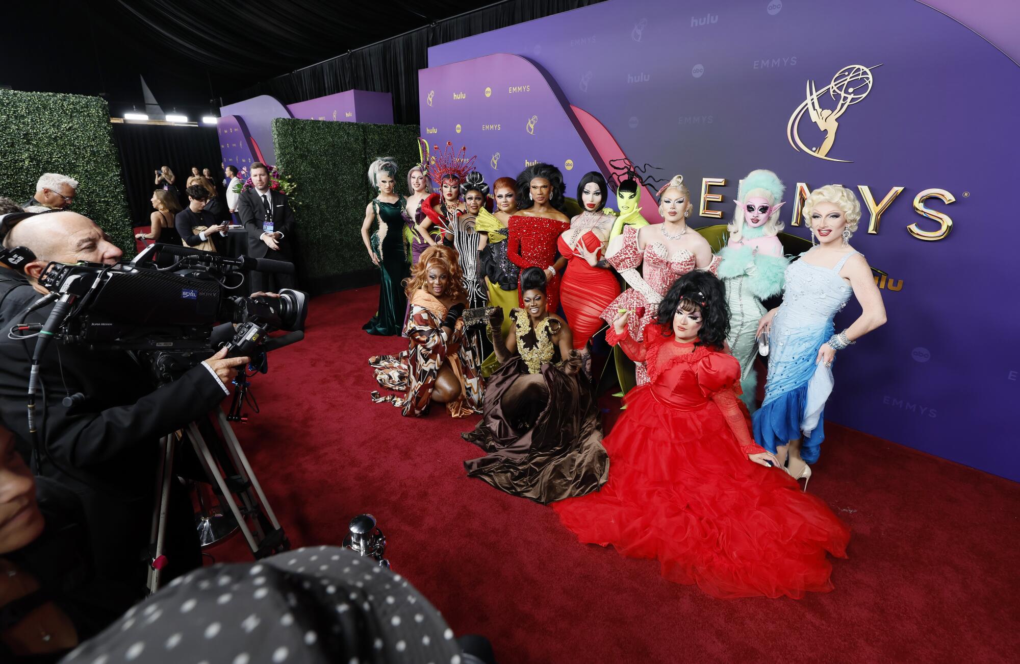 "RuPaul's Drag Race" contestants pose for cameras.