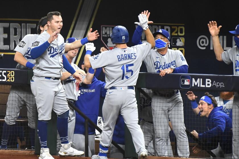 Dodgers manager Dave Roberts, right, greets Austin Barnes after Barnes homered in Game 3 of the World Series.