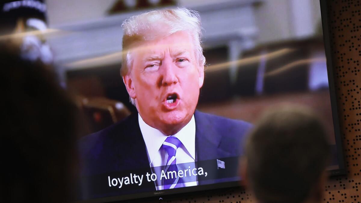 President Trump addresses new American citizens on a recording shown at a naturalization ceremony on Jan. 22 in Newark, N.J.