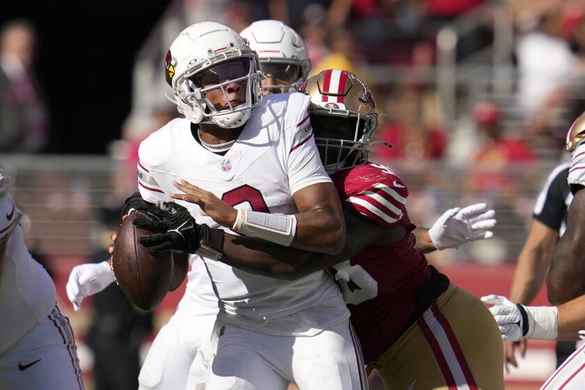 Arizona Cardinals quarterback Joshua Dobbs, left, is sacked by San Francisco 49ers defensive tackle Javon Hargrave during the second half of an NFL football game in Santa Clara, Calif., Sunday, Oct. 1, 2023. (AP Photo/Godofredo A. Vásquez)