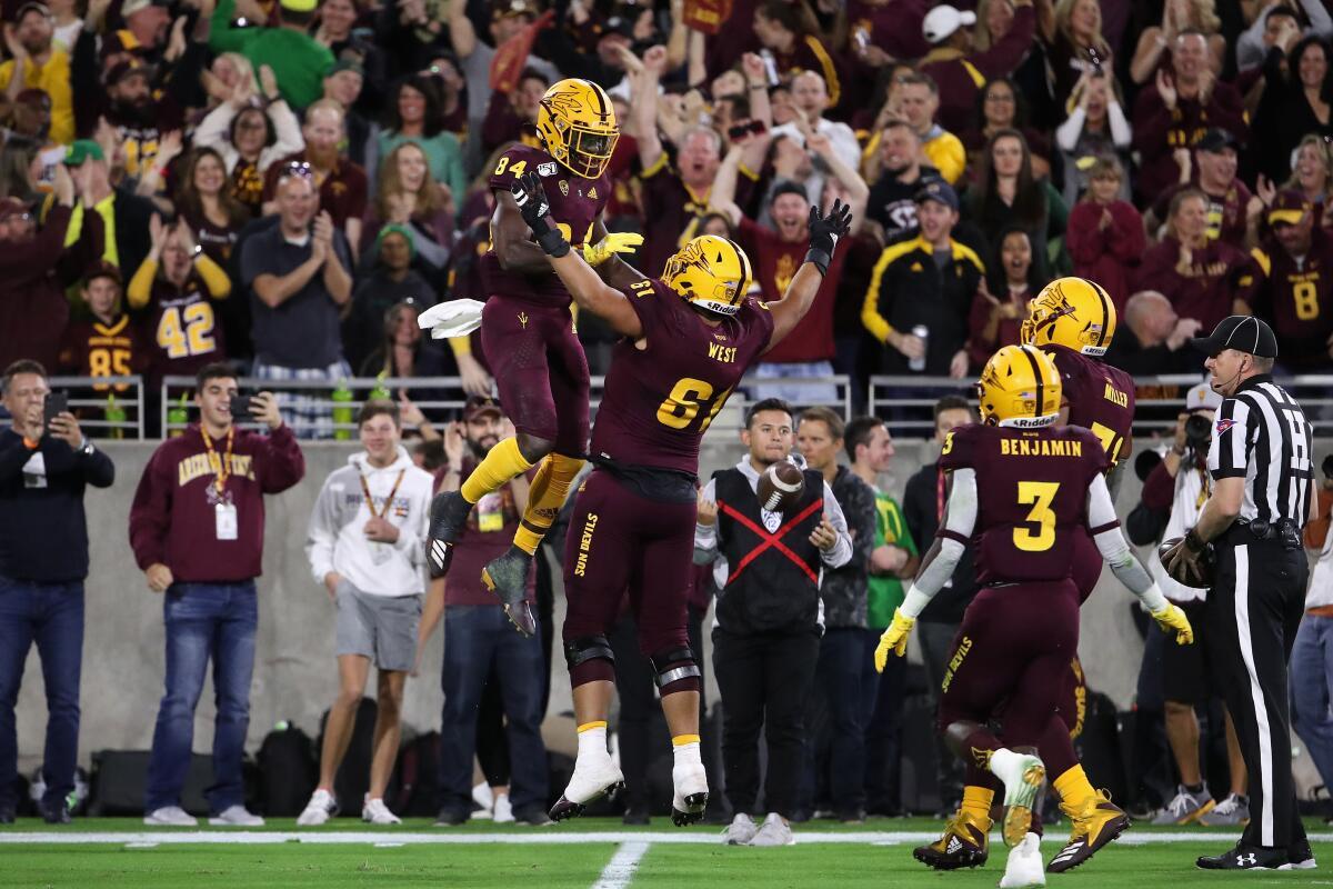 Arizona State's Frank Darby (84) celebrates with Dohnovan West after scoring a touchdown against Oregon on Nov. 23, 2019.