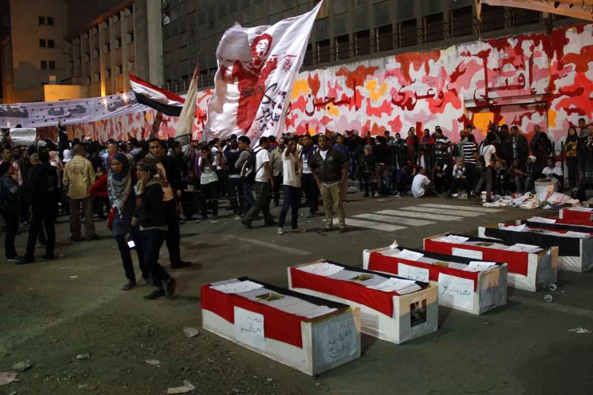 Egyptian protesters gather Tuesday in Mohammed Mahmoud Street just off Tahrir Square in Cairo alongside mock coffins representing the scores of people killed during clashes there in 2011 and 2012.