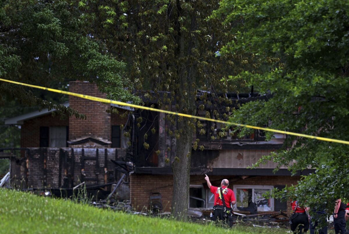 Fire officials look over the scene of a fatal house explosion on Friday, June 17, 2022, in northern St. Louis County just west of Spanish Lake, Mo. (Christian Gooden/St. Louis Post-Dispatch via AP)