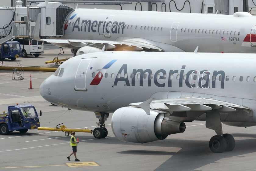FILE - American Airlines passenger jets prepare for departure, Wednesday, July 21, 2021, near a terminal at Boston Logan International Airport, in Boston. American Airlines Group Inc. (AAL) on Thursday, Jan. 20, 2022, reported a loss of $931 million in its fourth quarter. On a per-share basis, the Fort Worth, Texas-based company said it had a loss of $1.44. Losses, adjusted for non-recurring costs, came to $1.42 per share. (AP Photo/Steven Senne, File)