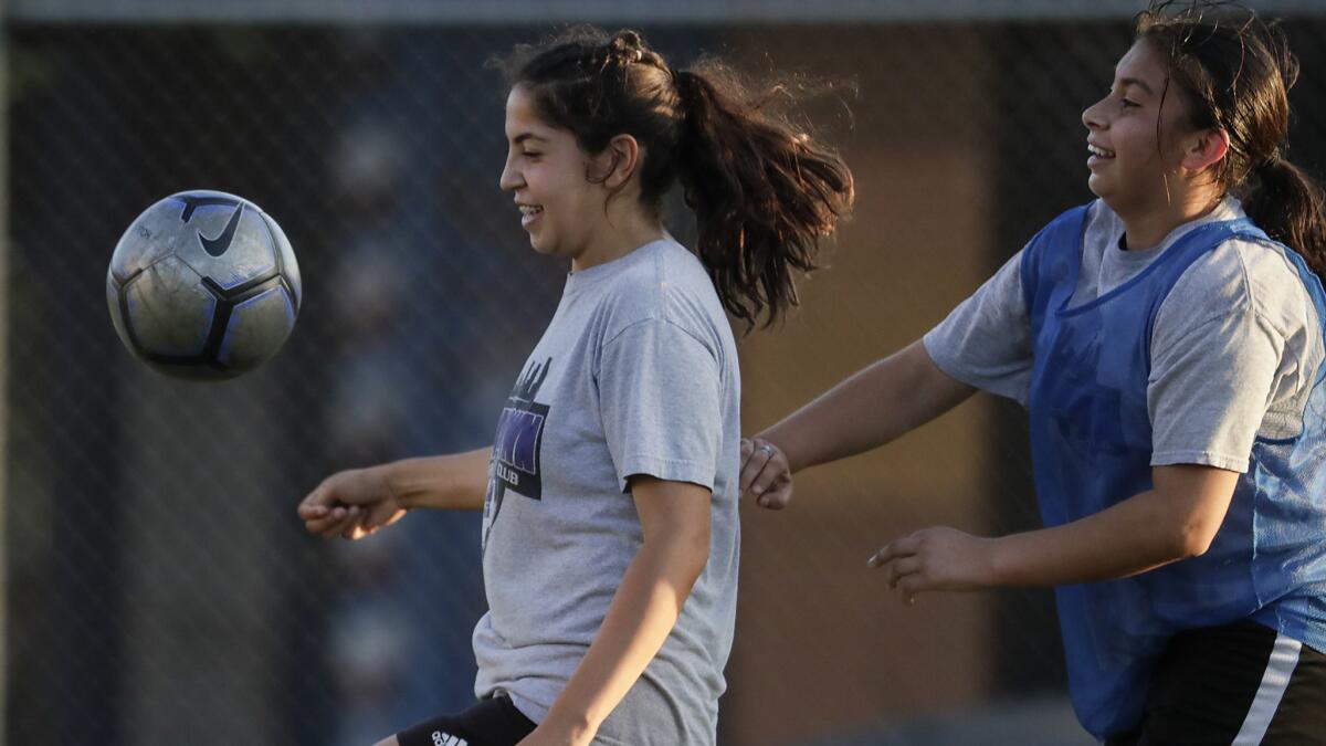 Downtown Los Angeles Soccer Club players Dunia Casula, left, and Michelle Bracamonte practice at Liechty Middle School.