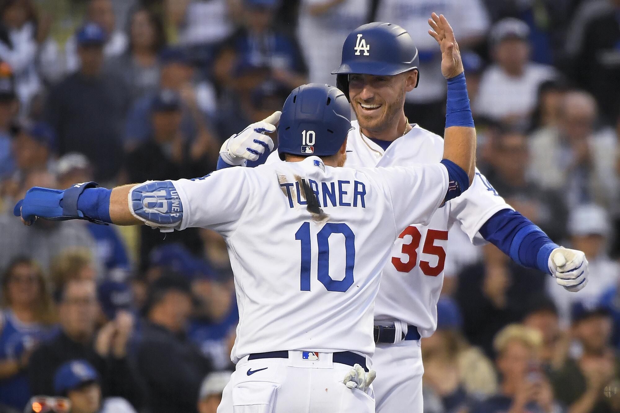 Cody Bellinger, right, celebrates with Dodgers teammate Justin Turner after hitting a two-run home run.